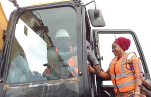 Amoako-Attah moving a tractor to symbolically start the project