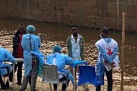 Passengers from intercepted boat await testing in Kinshasa