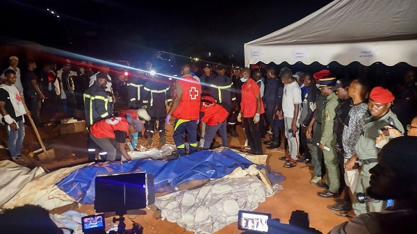 Rescuers prepare to carry bodies of the deceased from a landslide in Cameroon