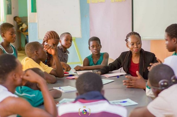 Students learning how to read with a volunteer