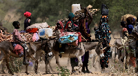 Sudanese refugees who fled the violence in Sudan's Darfur region and newly arrived ride their donkey