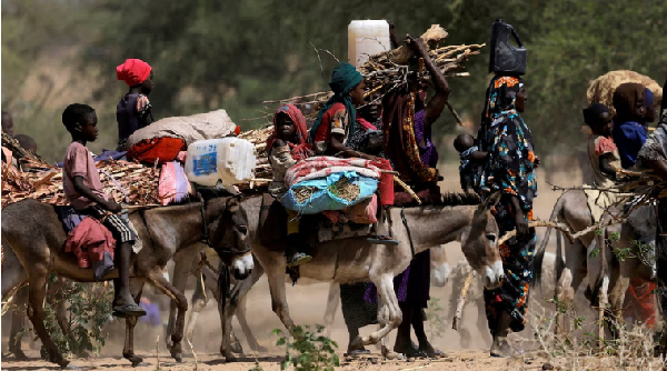 Sudanese refugees who fled the violence in Sudan's Darfur region and newly arrived ride their donkey