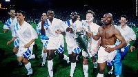 Abedi Pele with holding one-side of the trophy bare-chested