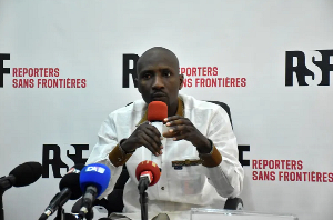 Burkinabe journalist Atiana Serge Oulon speaks at a news conference in Dakar, Senegal