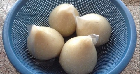 Four balls of banku inside a perforated bowl