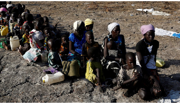 Women and children wait to be registered prior to a food distribution programme