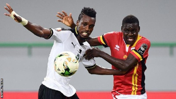 Uganda's forward Muhammad Shaban (right) challenges Ghana's defender John Boye