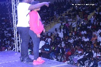 Nii Funny on stage with the pregnant woman