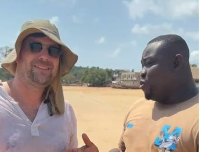 The German tourist (L) speaking with journalist Kwesi Parker-Wilson