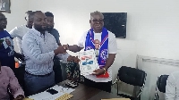 Paul Ansah Asare (right) presenting his nomination form to NPP's leadership