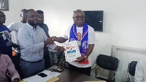 Paul Ansah Asare (right) presenting his nomination form to NPP's leadership