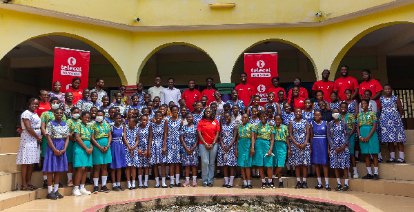 A photo of officials and some young girls