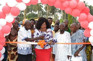 Queenstar Sawyer (M) cutting the tape for the newly built community center at Agona East