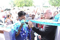 Gender Minister Otiko Djaba and US Ambassador Robert Jackson cut a ribbon to re-open the shelter