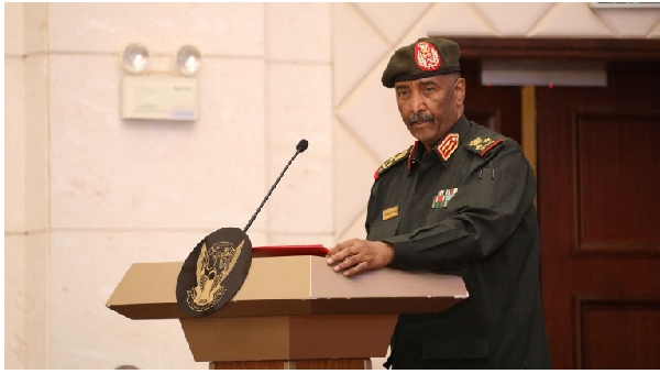 Sudan's military leader General Abdel Fattah al-Burhan stands at the podium during a ceremony