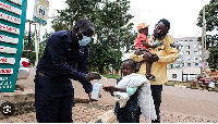 A girl sanitises her hands in front of Kibuli Muslim Hospital in Kampala, Uganda, May 16, 2026