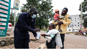 A girl sanitises her hands in front of Kibuli Muslim Hospital in Kampala, Uganda, May 16, 2026