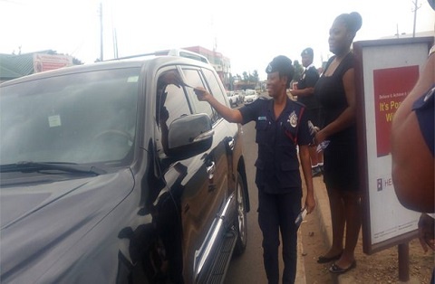 Some of the police personnel sharing flyers to motorists in traffic