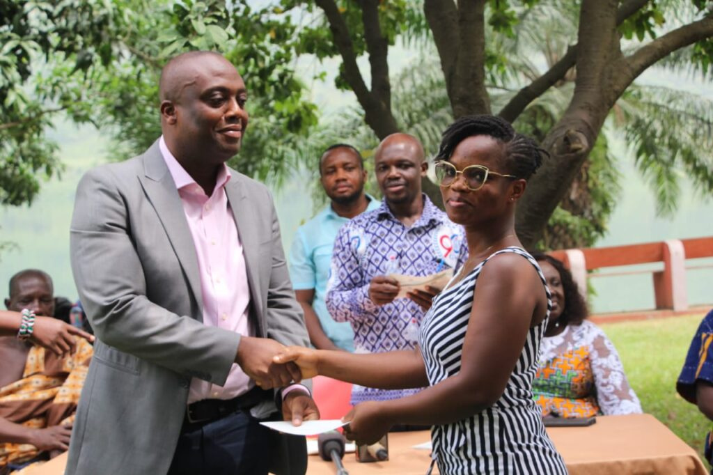 The MP handing over a bursury to one of the beneficiaries