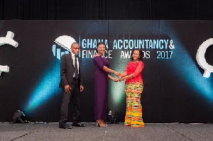 Frances-Marie Oduro, Finance Officer, PETROSOL (left) receiving the award from Dpty Finance Minister