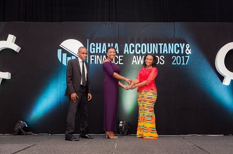 Frances-Marie Oduro, Finance Officer, PETROSOL (left) receiving the award from Dpty Finance Minister