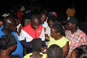 Charles Bissue interacting with some of the traders