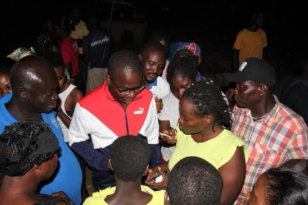 Charles Bissue interacting with some of the traders