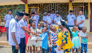Mustapha Salifu, President of the Association presenting a cash donation