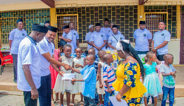 Mustapha Salifu, President of the Association presenting a cash donation