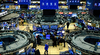 Traders work on the floor of the New York Stock Exchange at the opening bell in New York on December