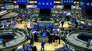 Traders work on the floor of the New York Stock Exchange at the opening bell in New York on December