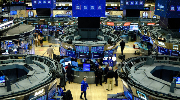 Traders work on the floor of the New York Stock Exchange at the opening bell in New York on December