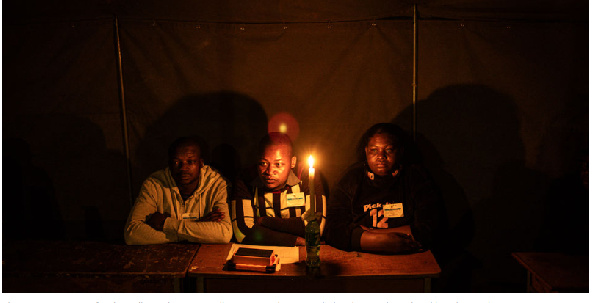 Election agents wait for the polls to close at a polling station during Zimbabwe's election