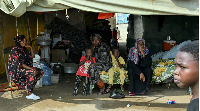 Dissplaced people sit inside a tent at a school turned into a shelter in Port Sudan