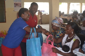 Yaw Ofori Owusu & Ms. Eleanora Agyei handing (Airtel Employees) handing over NAP to some mothers