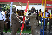 DCFO Edward Heyman handing over to ACFO Alfred Okine during pulling-out ceremony