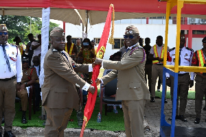 DCFO Edward Heyman handing over to ACFO Alfred Okine during pulling-out ceremony