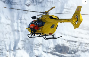A helicopter carries Lindsey Vonn of United States after she crashed during the women's downhill