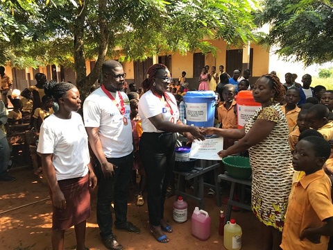 Members of the Rotaract Club of Aflao presenting the items to the schools