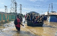 Some affected persons using canoe to move around in the flooded community.