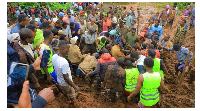 Residents digging to recover a dead body following the heavy rains