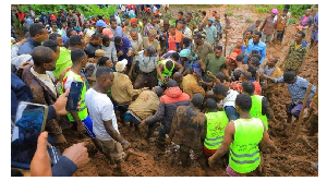 Residents digging to recover a dead body following the heavy rains