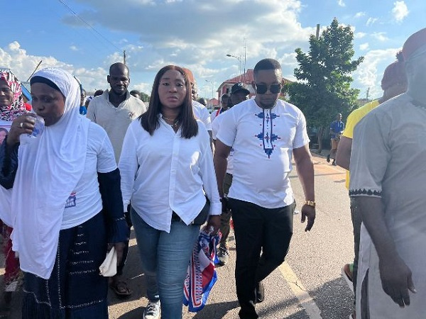 Gifty Ndoma (middle) and her supporters matching to pick up her nomination form