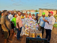 Michael Hoezade presenting the items to the flood victims