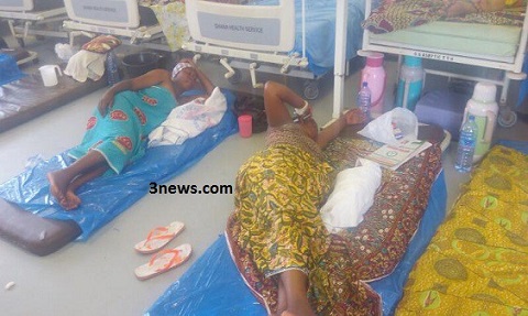 Some women lying on the floor at a hospital due to lack of beds