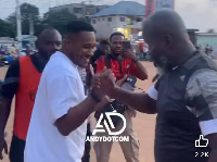 Asamoah Gyan (L) shaking the hands of Kuffour (R)