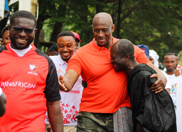 Herbert Mensah shares a warm embrace with a man