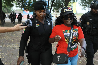 One of the anti-galamsey protesters being escorted by the police