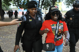 One of the anti-galamsey protesters being escorted by the police