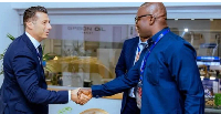 Dr John Jinapor shaking hands with investment partner